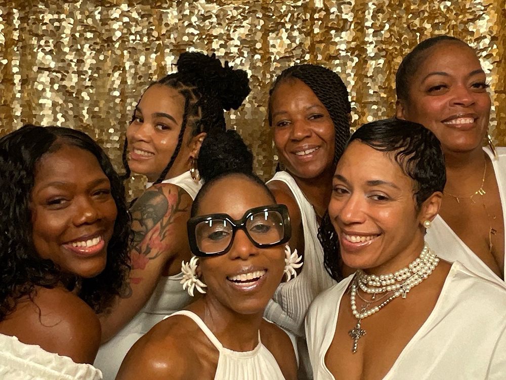 Guests posing at a 50th birthday photo booth