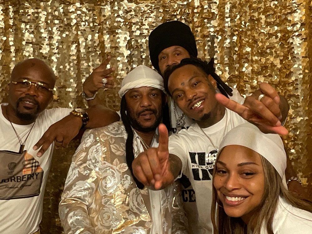 Group posing at a 50th birthday photo booth