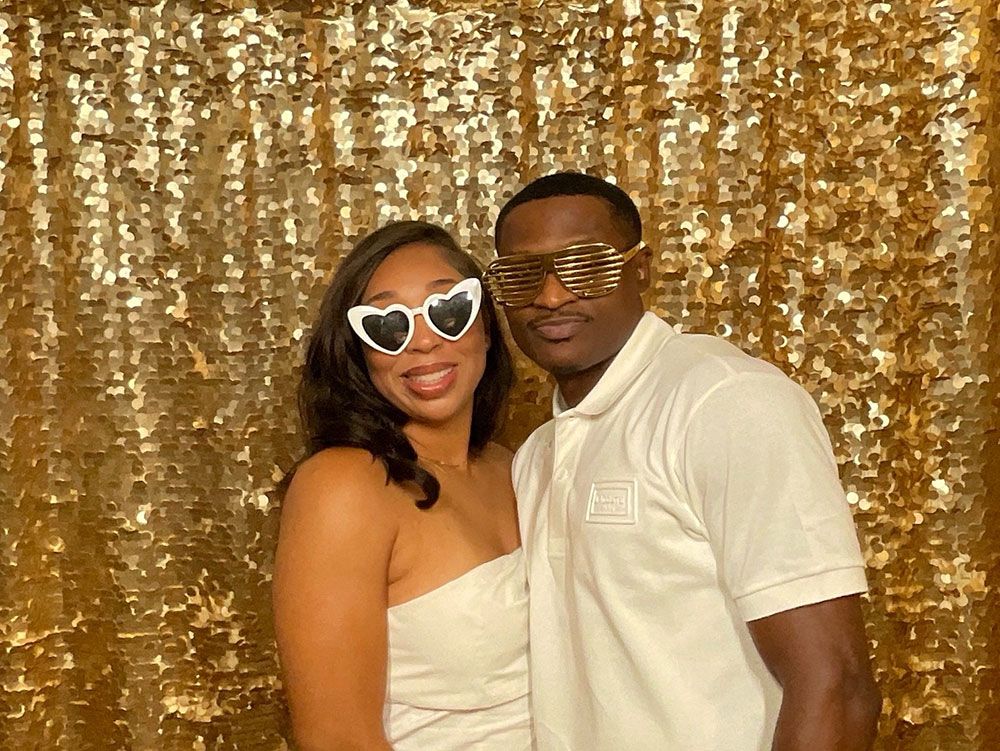 Couple posing at a 50th birthday photo booth