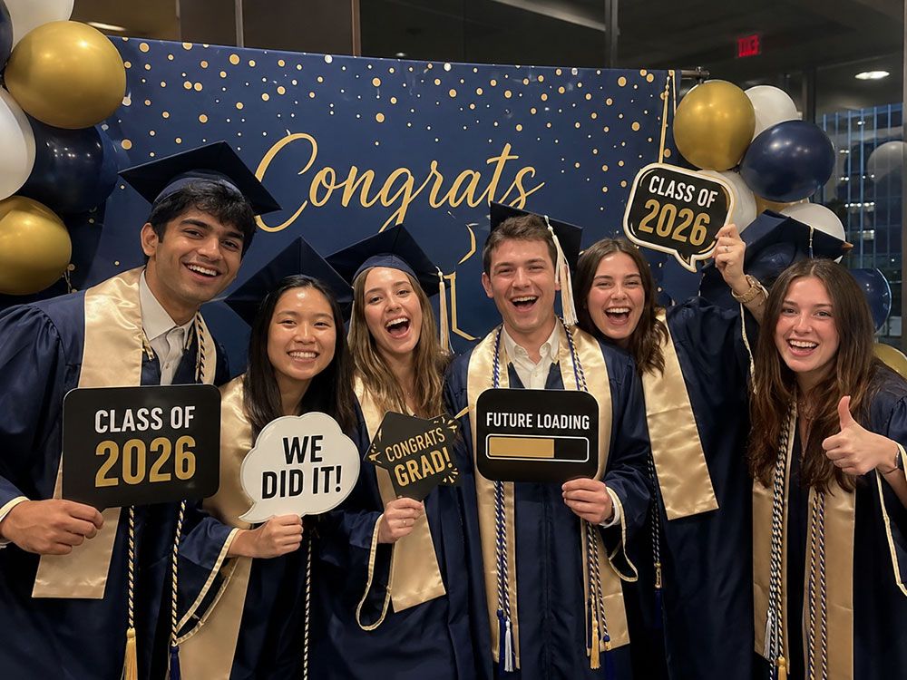 Graduates posing at a VIMO Events photo booth