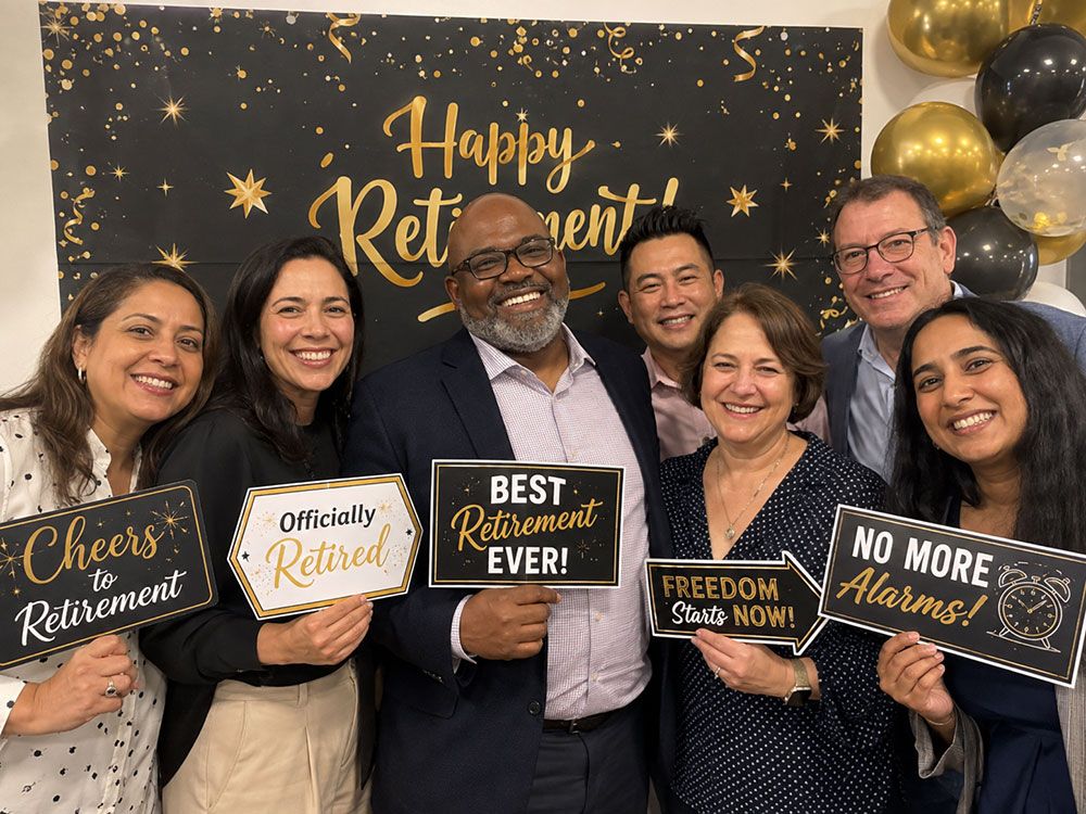 Guests posing at a retirement party photo booth