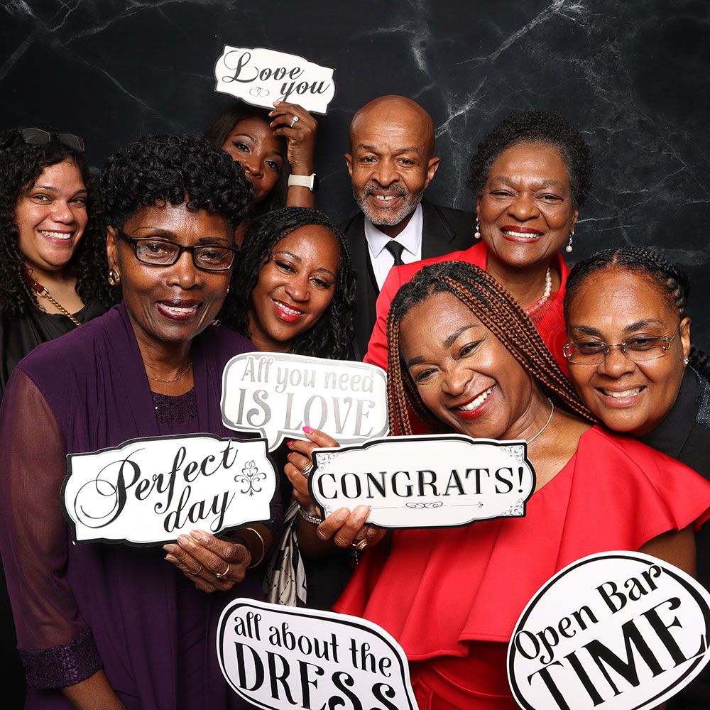 Family posing at a wedding photo booth